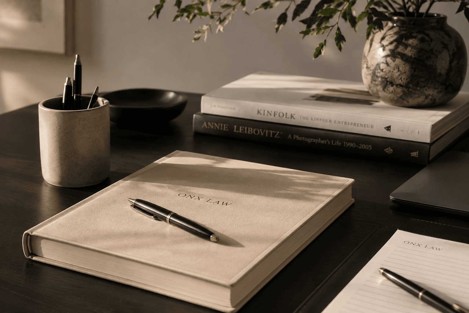 An Onx Law notebook and a pen on a desk
